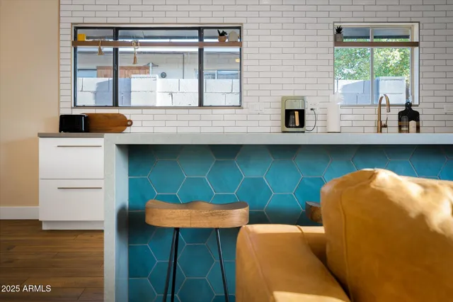 a kitchen with stainless steel appliances granite countertop a stove a sink and a dishwasher next to a window