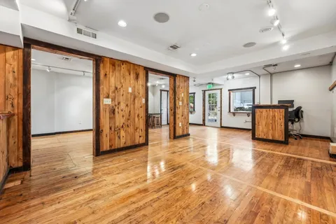 a view of an entryway with wooden floor