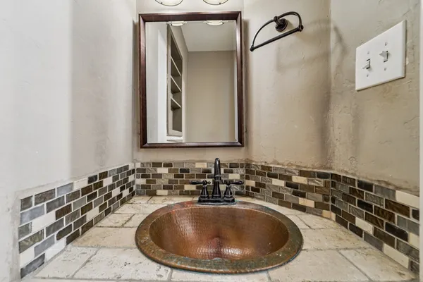 a bathroom with a sink and a mirror