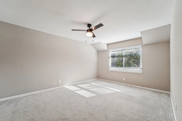 a view of a room with windows and ceiling fan