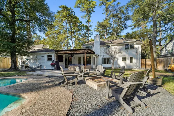 a view of a house with swimming pool and sitting area