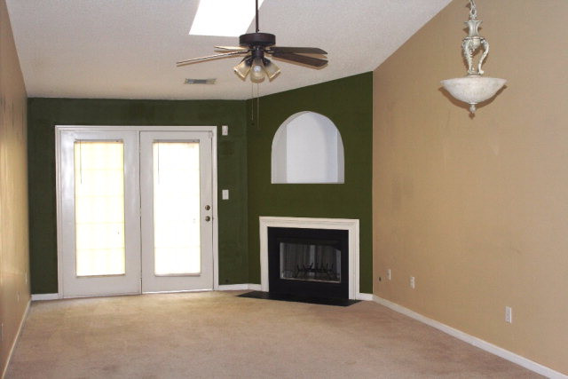 112 Single Tree Lane Aiken, SC 29803 - Photo 2 of 11 an empty room with a fireplace and fan