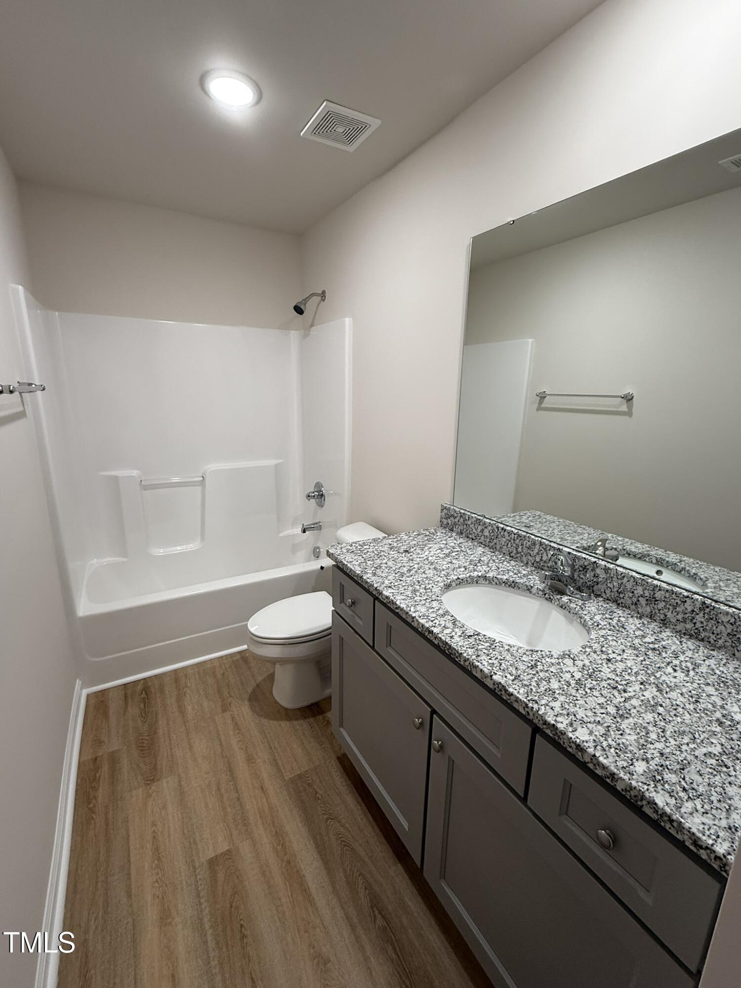 73 Phil Jack Road Dunn, NC 28334 - Photo 15 of 17 a bathroom with a granite countertop sink a toilet and shower