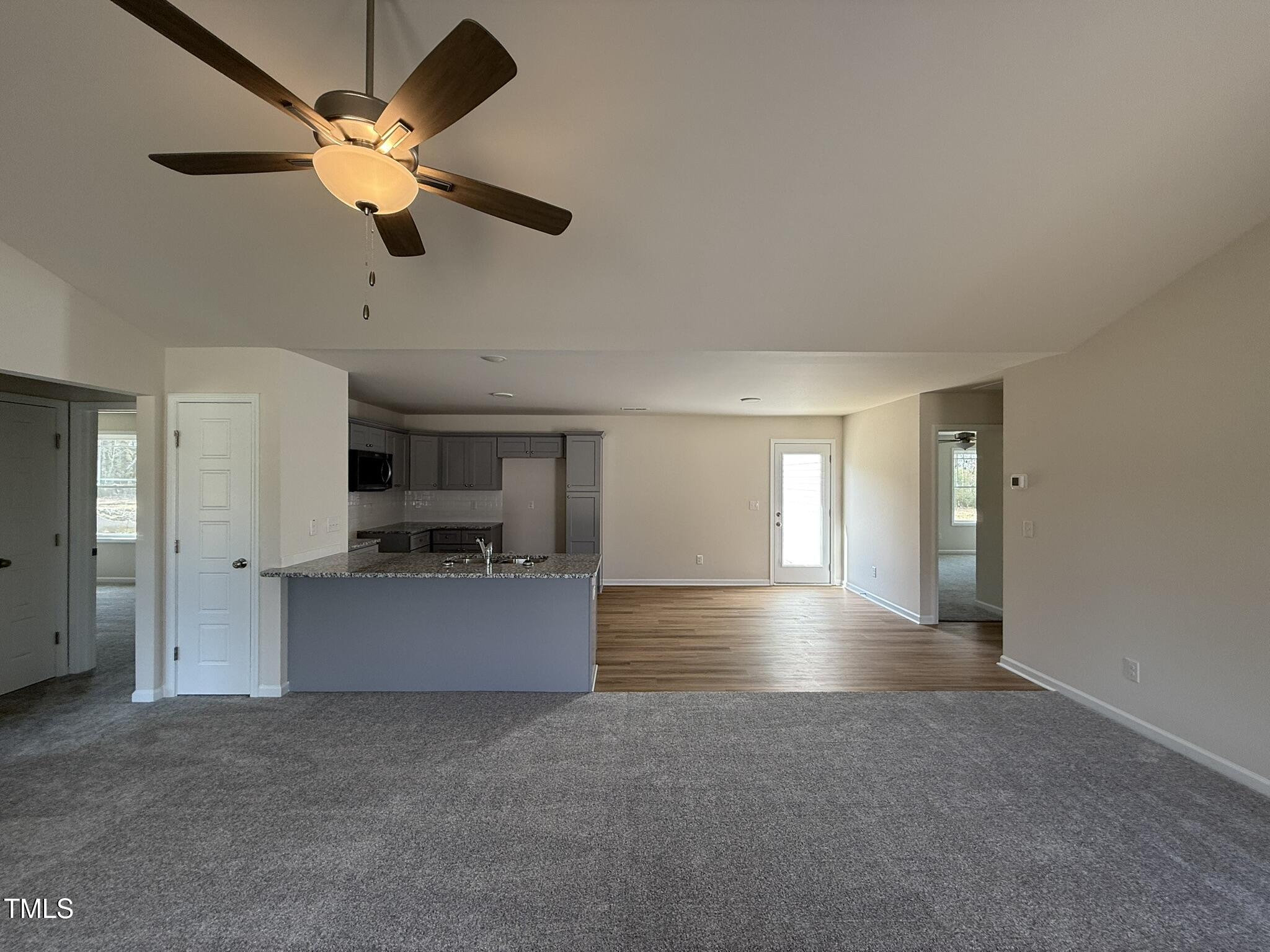 73 Phil Jack Road Dunn, NC 28334 - Photo 7 of 17 a view of a kitchen with a sink and a ceiling fan