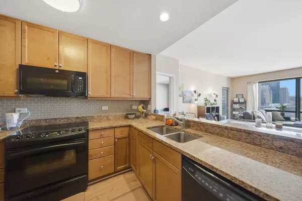 a kitchen with a sink stove and microwave