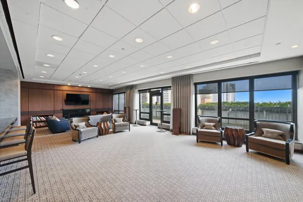 a living room with furniture large window and a flat screen tv