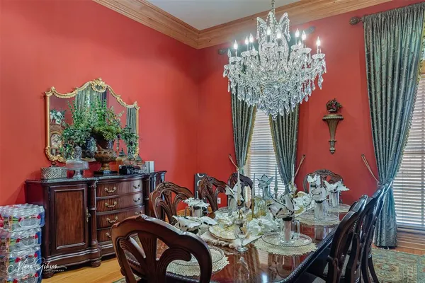a dining room with furniture and chandelier