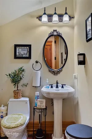 a bathroom with a toilet a sink and a mirror