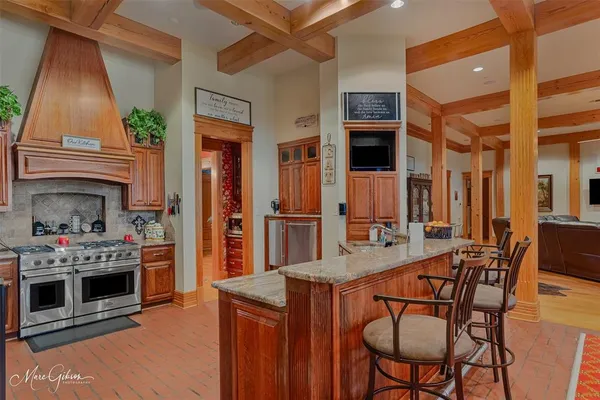 a kitchen with a stove a refrigerator and a fireplace