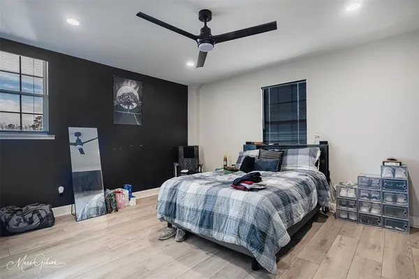 a bedroom with a bed and wooden floor