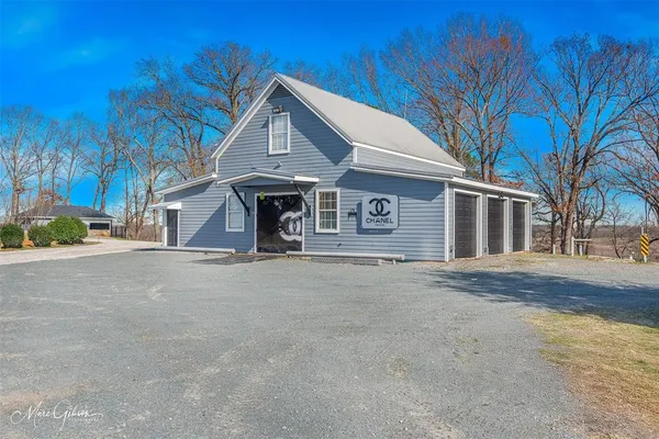 a front view of a house with a road and garage