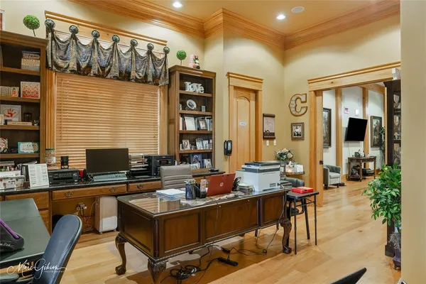 a living room with furniture a flat screen tv and a table