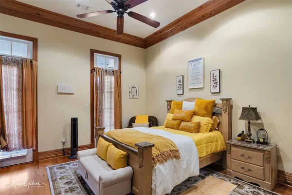 a bedroom with a bed and wooden floor