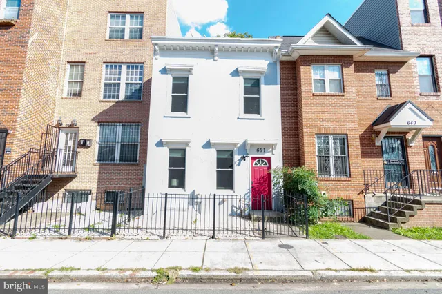 a living room with furniture a rug and a flat screen tv