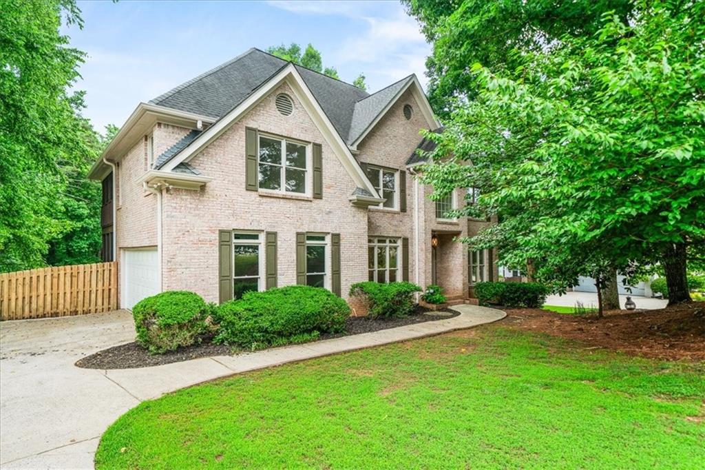 1710 Rising Mist Lane Cumming, GA 30041 - Photo 1 of 111 a front view of a house with a yard