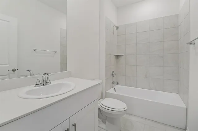 a bathroom with a sink a toilet and a bathtub