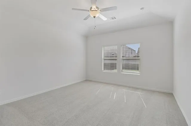 a view of a livingroom with a ceiling fan and window