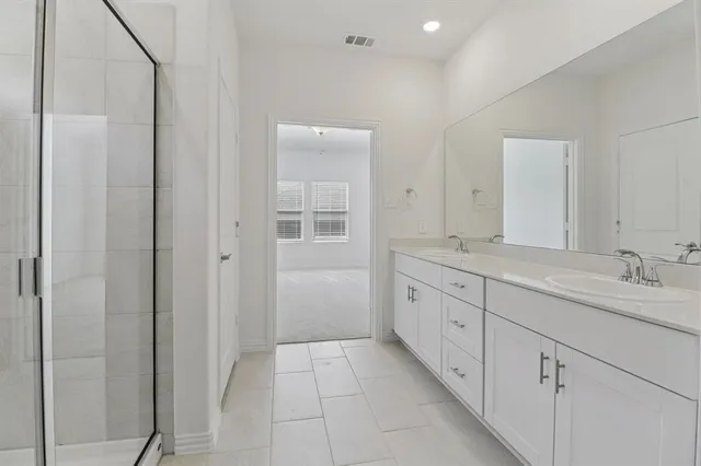 a spacious bathroom with a granite countertop sink a mirror and a