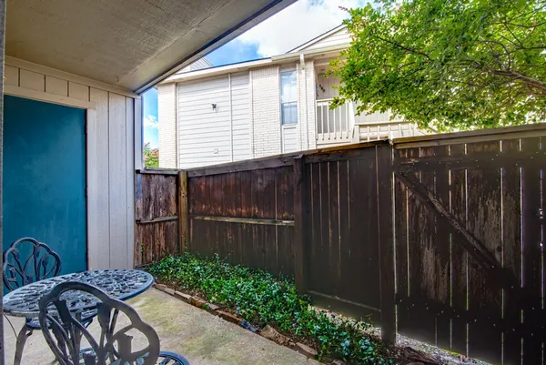 a backyard of a house with table and chairs