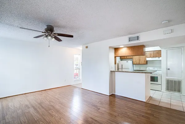 a kitchen with a refrigerator and white cabinets