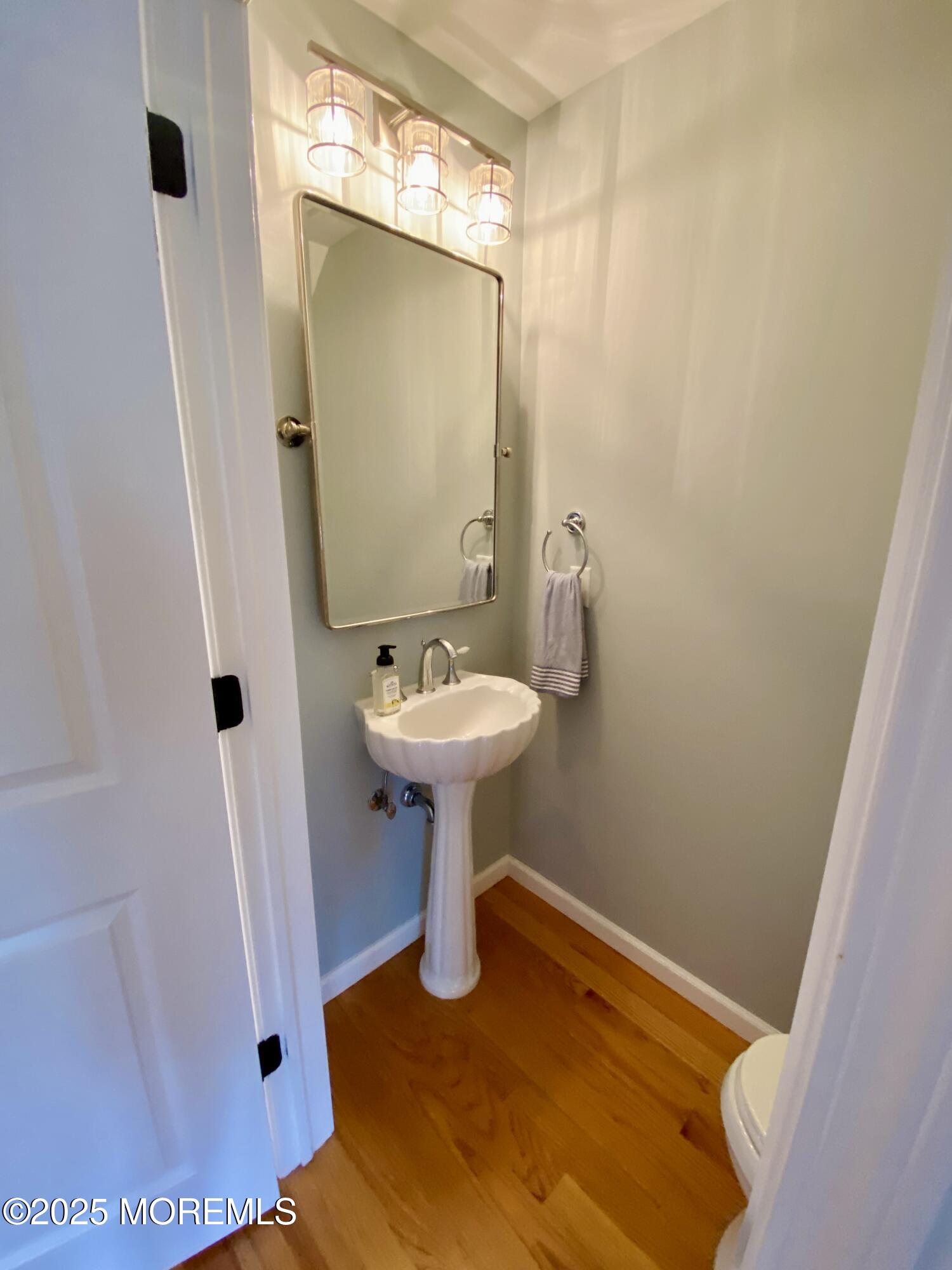 32 1st Street Rumson, NJ 07760 - Photo 11 of 25 a bathroom with a sink and mirror