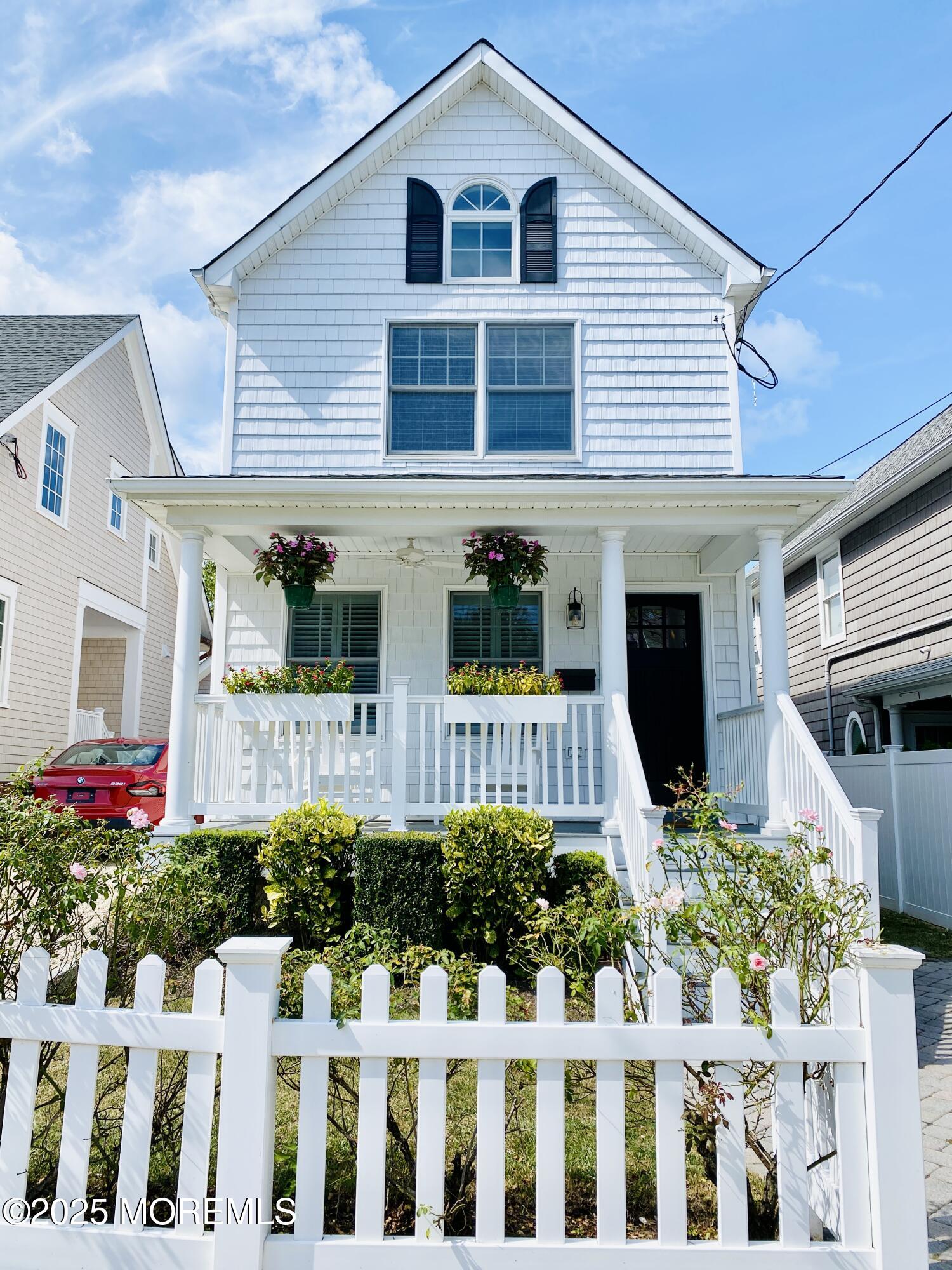 32 1st Street Rumson, NJ 07760 - Photo 2 of 25 a front view of a house with a garden