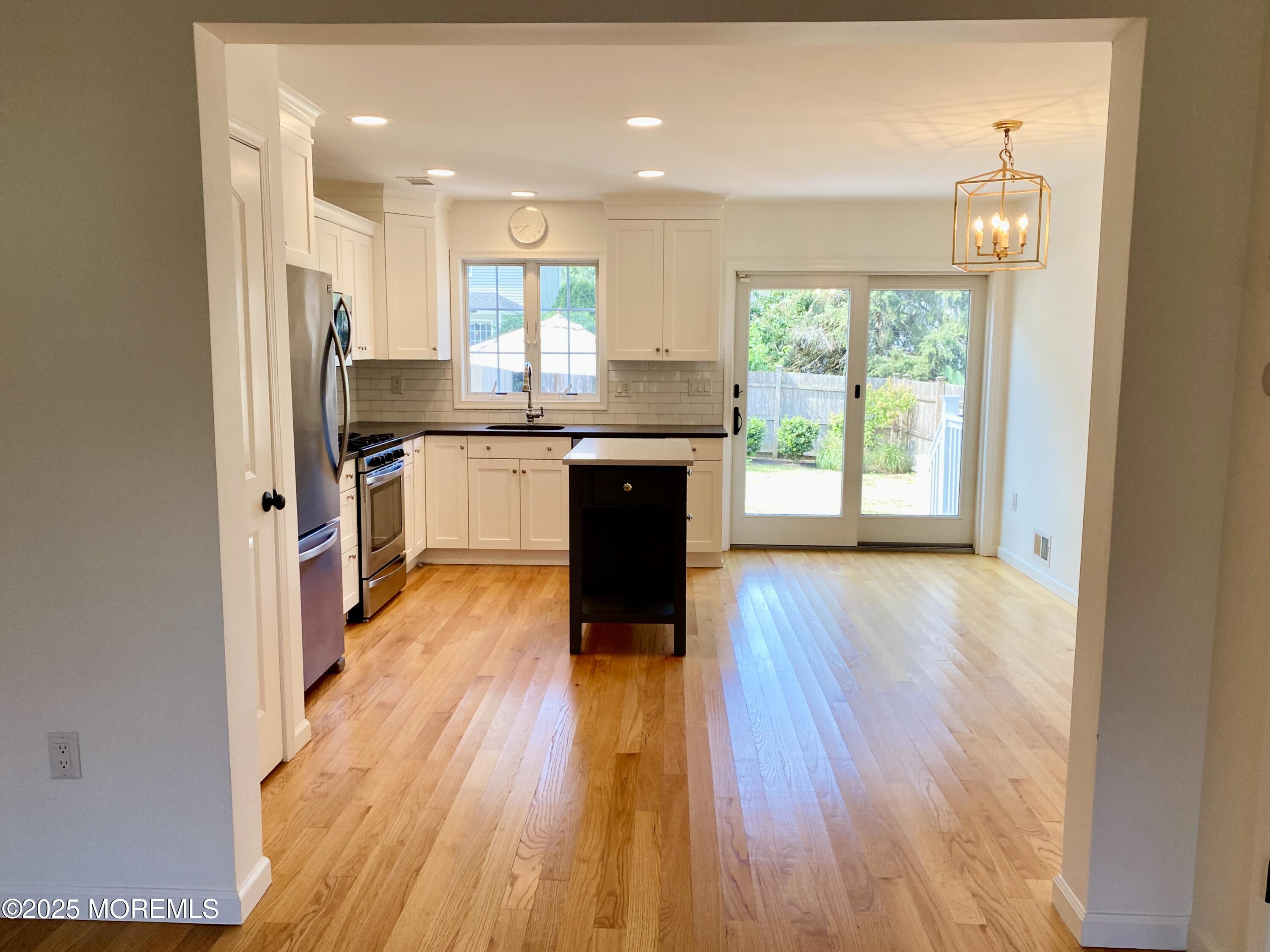 32 1st Street Rumson, NJ 07760 - Photo 6 of 25 a kitchen with a wooden floor window and a view of kitchen