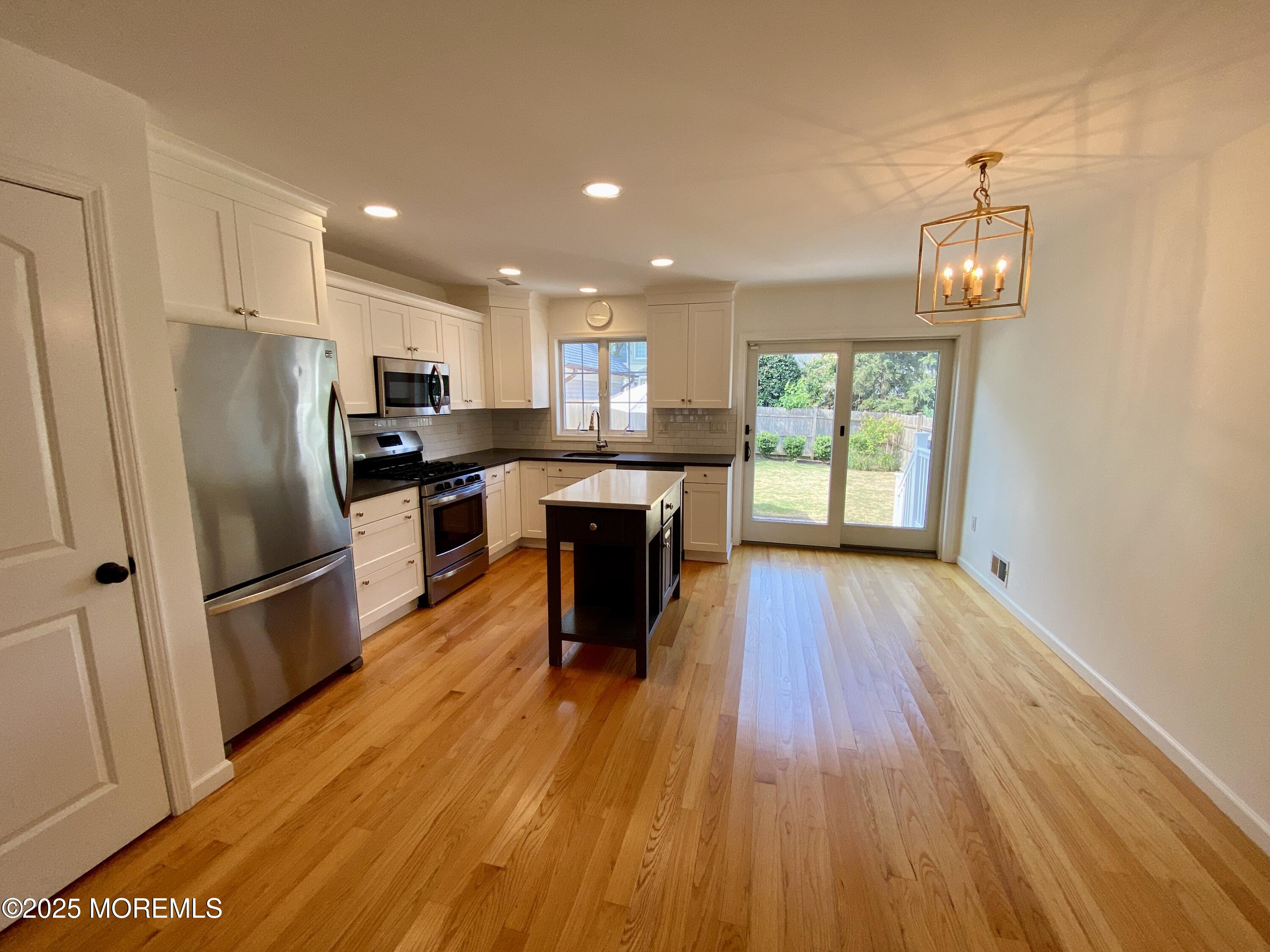 32 1st Street Rumson, NJ 07760 - Photo 7 of 25 a view of a kitchen with a sink refrigerator and wooden floor