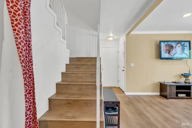 a view of an entryway with wooden floor