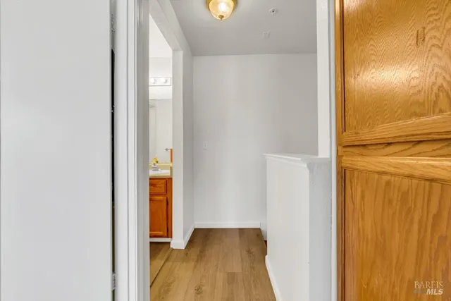 a view of a hallway with wooden floor