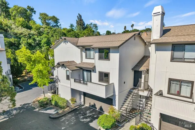 a front view of a house with a garden and plants