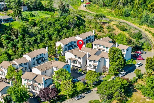 an aerial view of a house with a yard and garden
