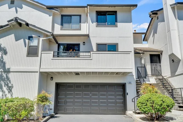 a front view of a house with plants
