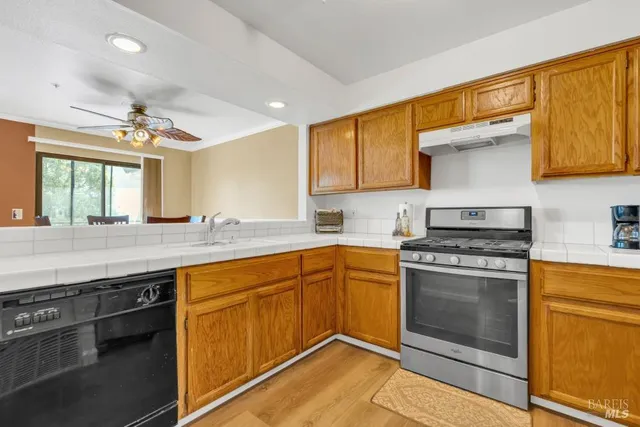 a kitchen with stainless steel appliances granite countertop a stove and a sink