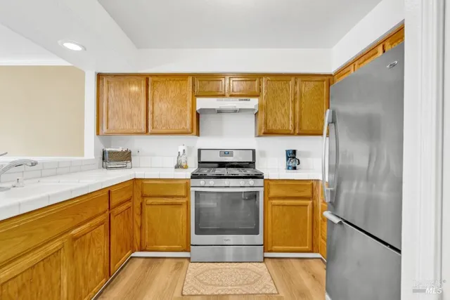 a kitchen with a stove top oven cabinets and stainless steel appliances