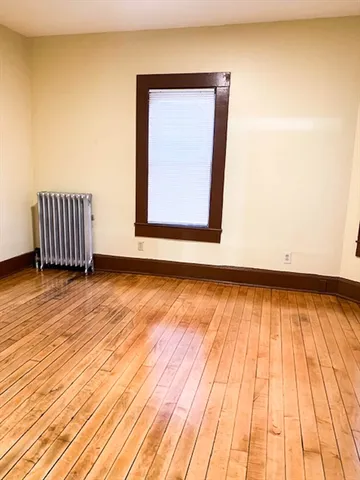 a view of a room with wooden floor and white walls