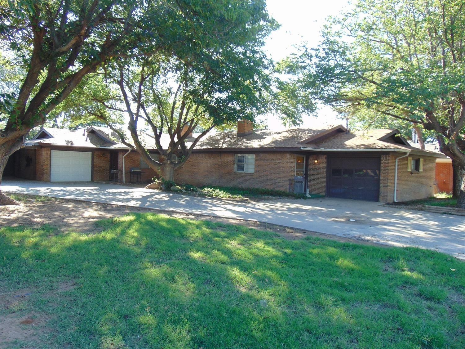 6903 Hartford Avenue Lubbock, TX 79413 - Photo 1 of 1 a view of a yard with a house and a large tree