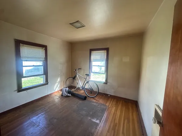 a view of a room with wooden floor and windows