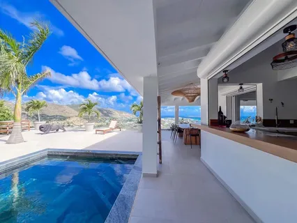 a view of living room with kitchen island furniture and a floor to ceiling window