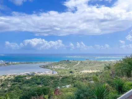 a dining room with furniture and a floor to ceiling window