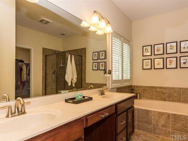 2903 Red Grape Drive Raleigh, NC 27607 - Photo 15 of 25 a bathroom with a sink double vanity and a bathtub