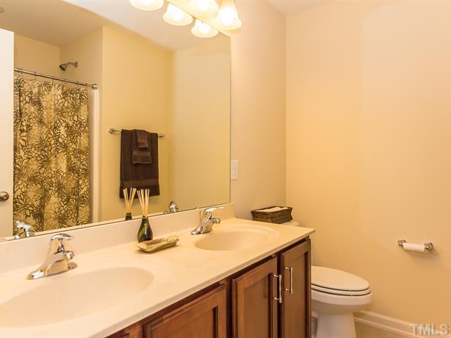 2903 Red Grape Drive Raleigh, NC 27607 - Photo 21 of 25 a bathroom with a granite countertop sink and a mirror