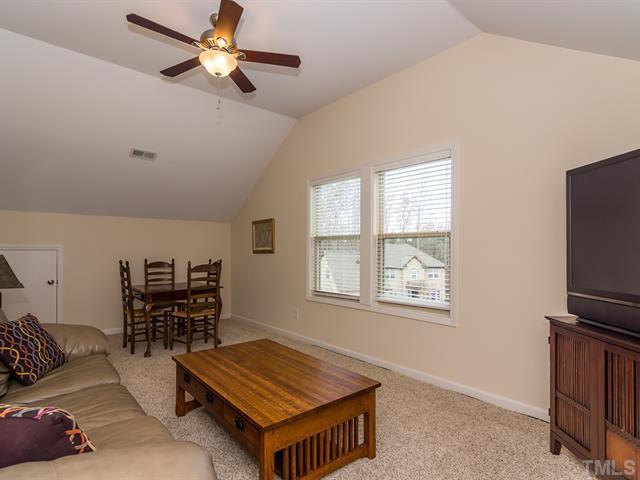 2903 Red Grape Drive Raleigh, NC 27607 - Photo 22 of 25 a living room with furniture a dining table and a window