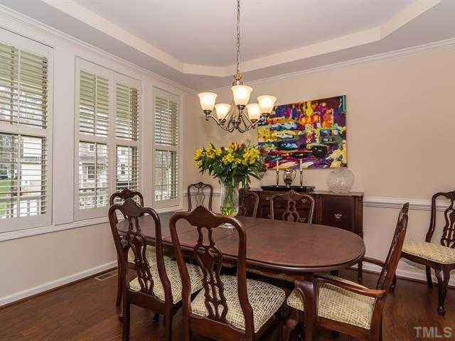 2903 Red Grape Drive Raleigh, NC 27607 - Photo 4 of 25 a dining room with furniture potted plants and wooden floor