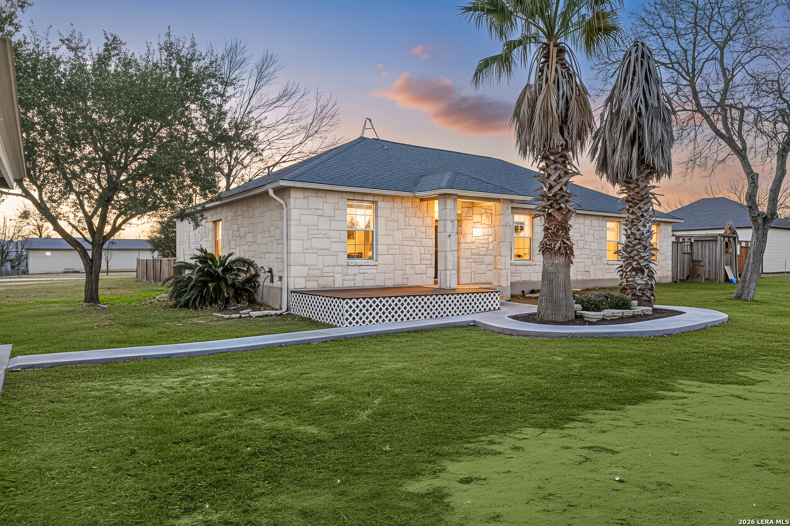 a view of a house with a yard patio and swimming pool