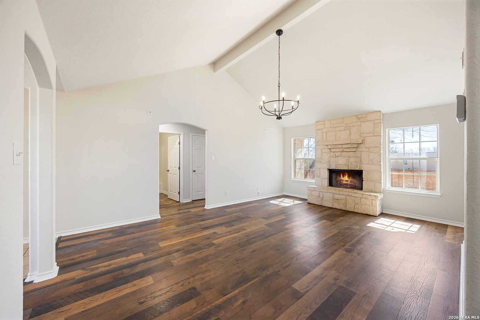 18181 Senior Road Von Ormy, TX 78073 - Photo 11 of 46 a view of an empty room with wooden floor fireplace and a window