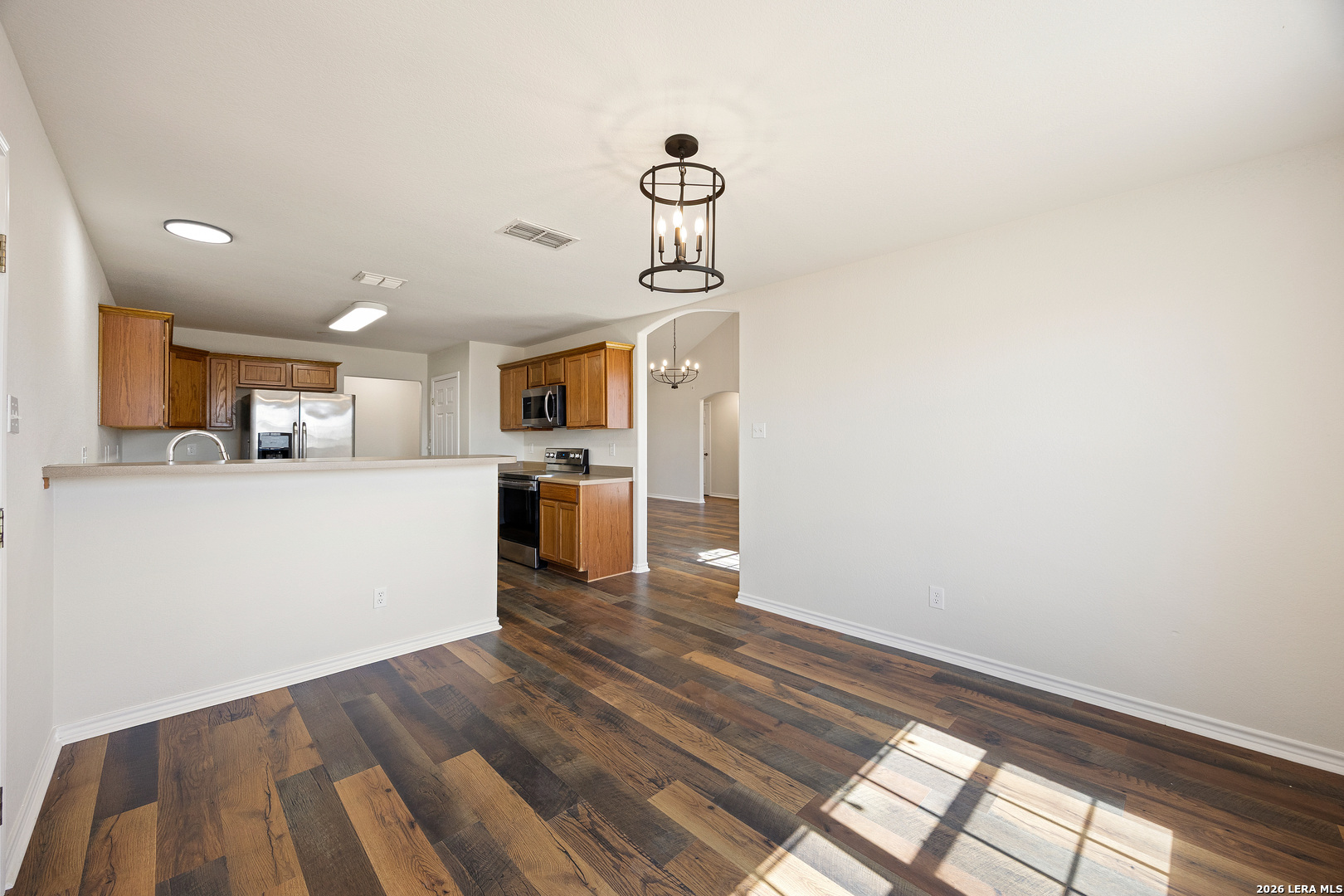 18181 Senior Road Von Ormy, TX 78073 - Photo 14 of 46 a view of a kitchen with wooden floor and a window