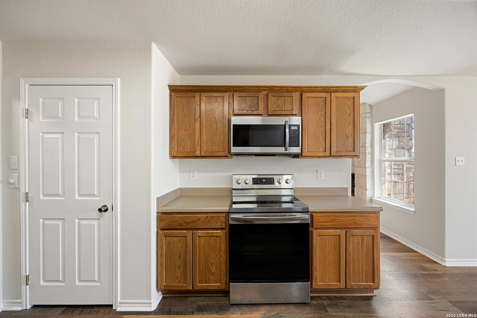 18181 Senior Road Von Ormy, TX 78073 - Photo 17 of 46 a kitchen with stainless steel appliances granite countertop a stove and a microwave