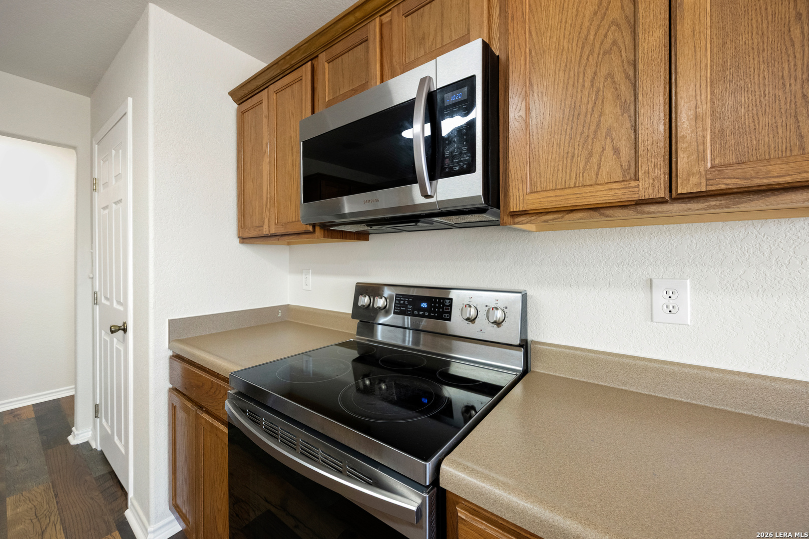 18181 Senior Road Von Ormy, TX 78073 - Photo 19 of 46 a kitchen with a stove and a microwave