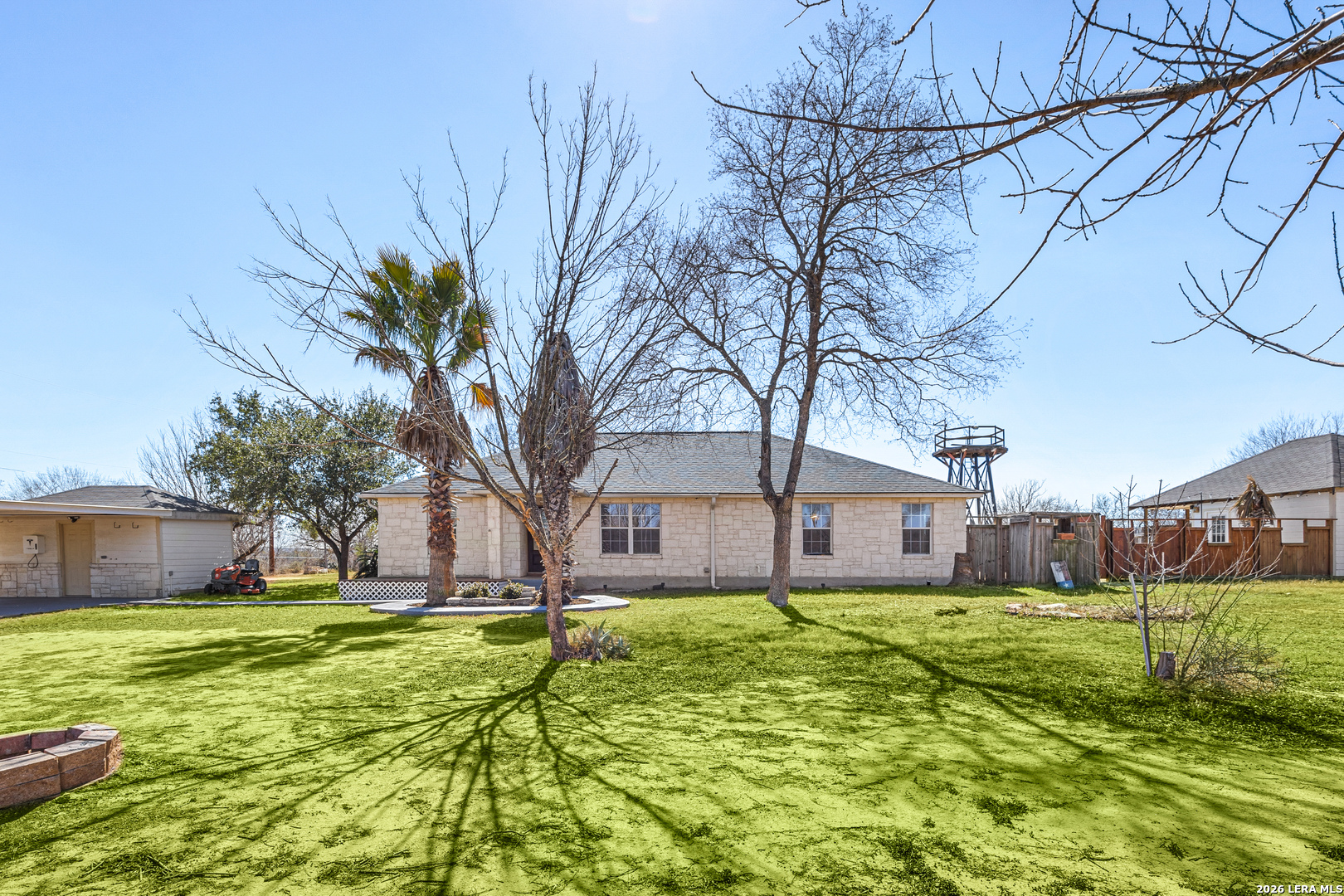18181 Senior Road Von Ormy, TX 78073 - Photo 2 of 46 a house view with swimming pool in front of yard
